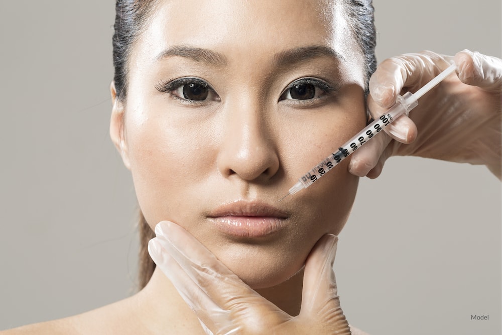 Asian woman undergoing BOTOX® Cosmetic injections.